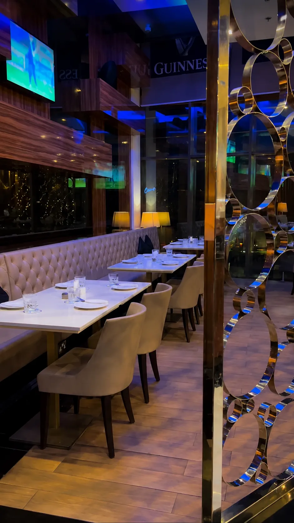 Interior dining booths with a decorative golden ring divider