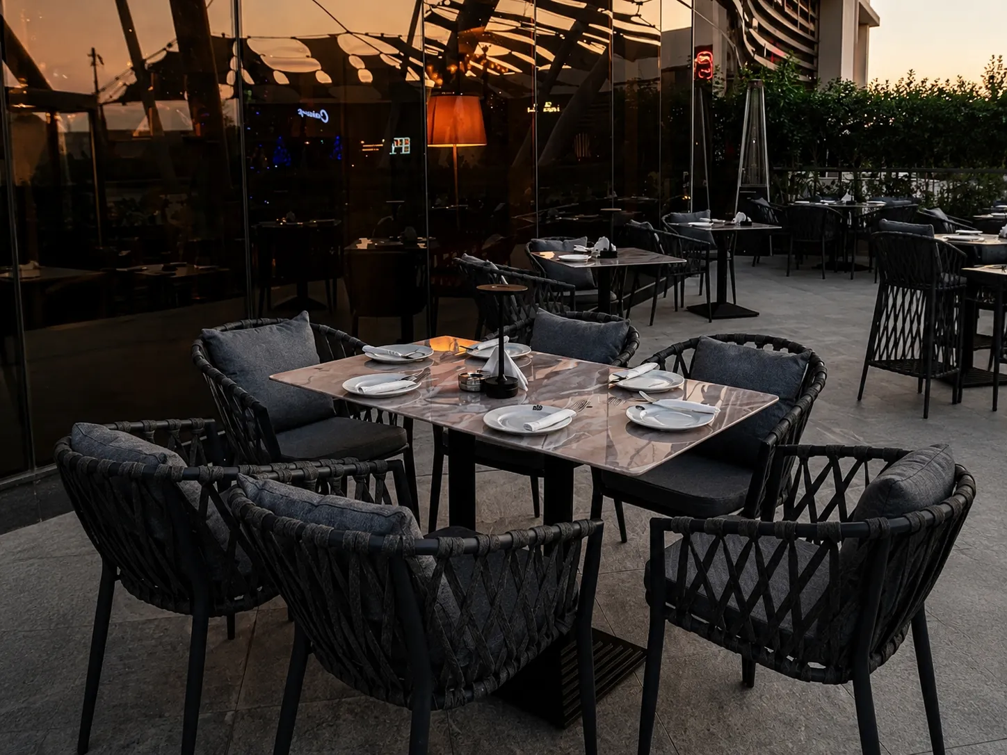 Outdoor patio setting with woven chairs and a marble table